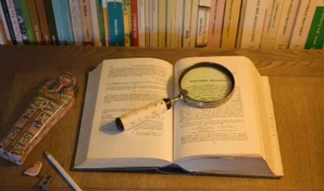 Book with magnifying glass